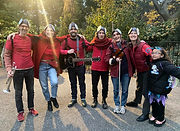 The Burning Hell, dressed as lantern flies, pose for a photo with friends.
