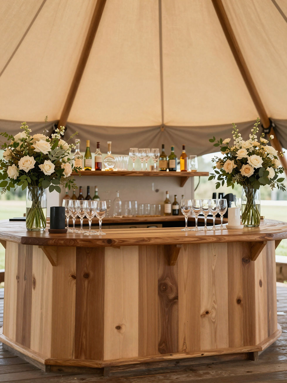 Rustic wooden bar, a tipi event add on with floral decor.