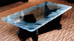 The beauty of a custom coffee table made of raw-cut steel and etched glass is truly captivating. The combination of industrial steel with delicate etched glass creates a unique and elegant piece of furniture that would be a stunning addition to any home. The raw-cut steel gives the table a rugged and industrial feel, while the etched glass adds a touch of sophistication and refinement. This custom coffee table is not only a functional piece of furniture but also a work of art that can elevate the aesthetic of any living space.