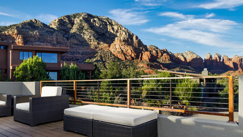 Rooftop Skydeck patio on a modern Sedona home featuring outdoor lounge seating and spectacular daytime views of Thunder Mountain and Coffee Pot Rock.