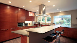 The kitchen island design is truly exceptional, featuring a split-level design that cleverly hides the cooking area, doubling up as a spot for meal preparation and entertaining guests with the addition of barstools. The newly installed windows offer stunning views of the backyard, seamlessly blending the outdoors with the kitchen environment.
Overall, this kitchen island design perfectly combines functionality and style. It's a space where you can create delicious meals while socializing with guests, all while enjoying glimpses of the beautiful outdoor scenery through the new windows.