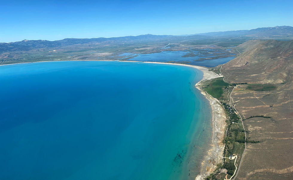 Aerial view of a turquoise bay and sandy shoreline.