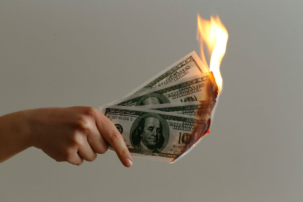A hand holds burning banknotes, symbolising financial loss or reckless spending. Most brands think they’re investing in growth with influencer marketing, but in reality, they’re