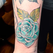Blue rose tattoo on the wrist by Olivia at Acme Tattoo Co.