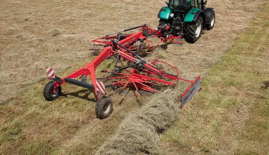 GA 6930 / 7530 / 8030/ 8830 Twin-Rotor Rotary Rake attached to tractor rear, in field