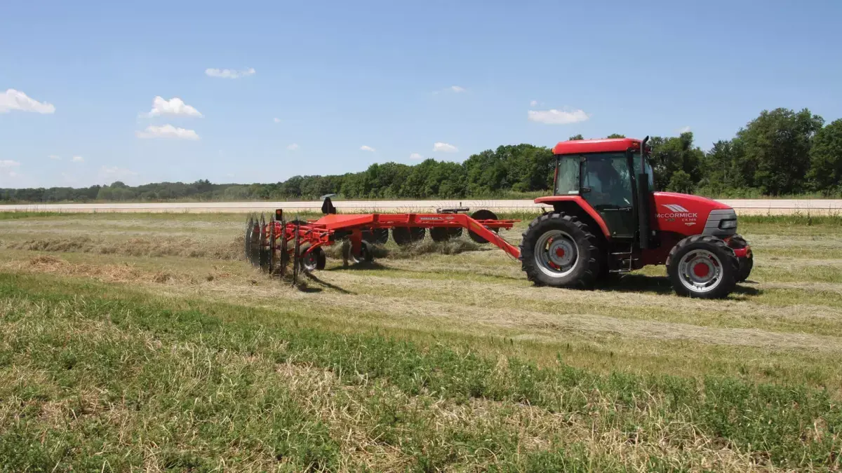 SR 300 Series Wheel Rake attached to tractor rear, in field
