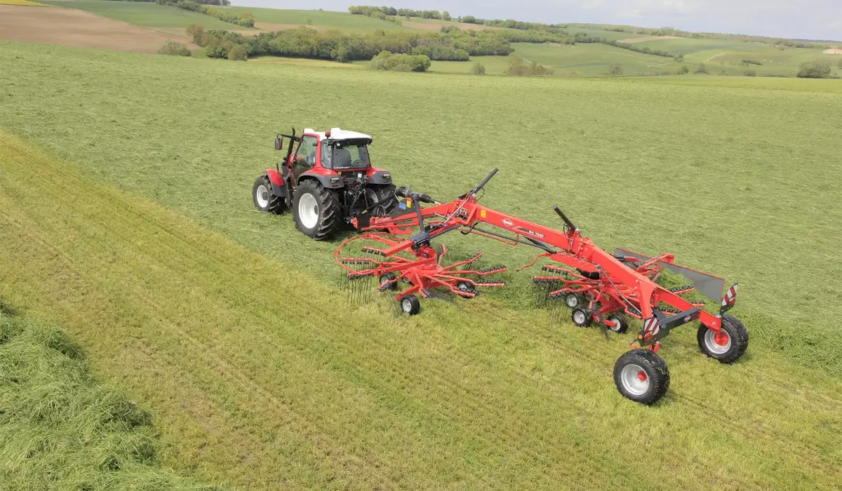 GA 1032+ Series Twin-Rotor Rotary Rake attached to tractor rear, in field