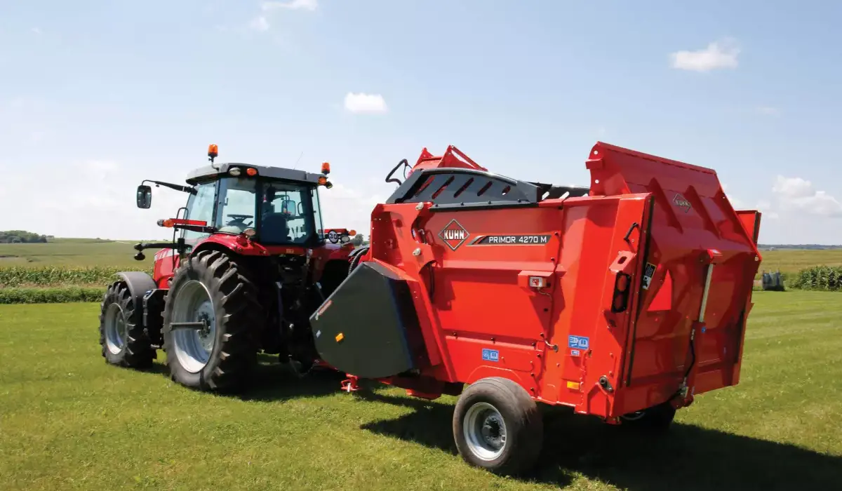 KUHN PRIMOR Bale Processor attached to tractor rear in field