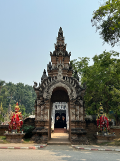 arched entrance to wat lok moli from across the street in chiang mai thailand