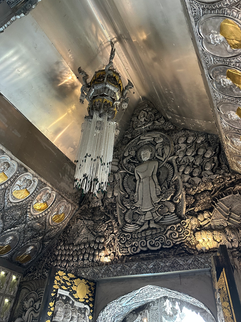 design of buddha above entrance in silver temple in chiang mai thailand