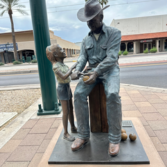 metal sculpture of a cowboy and child in mesa arizona