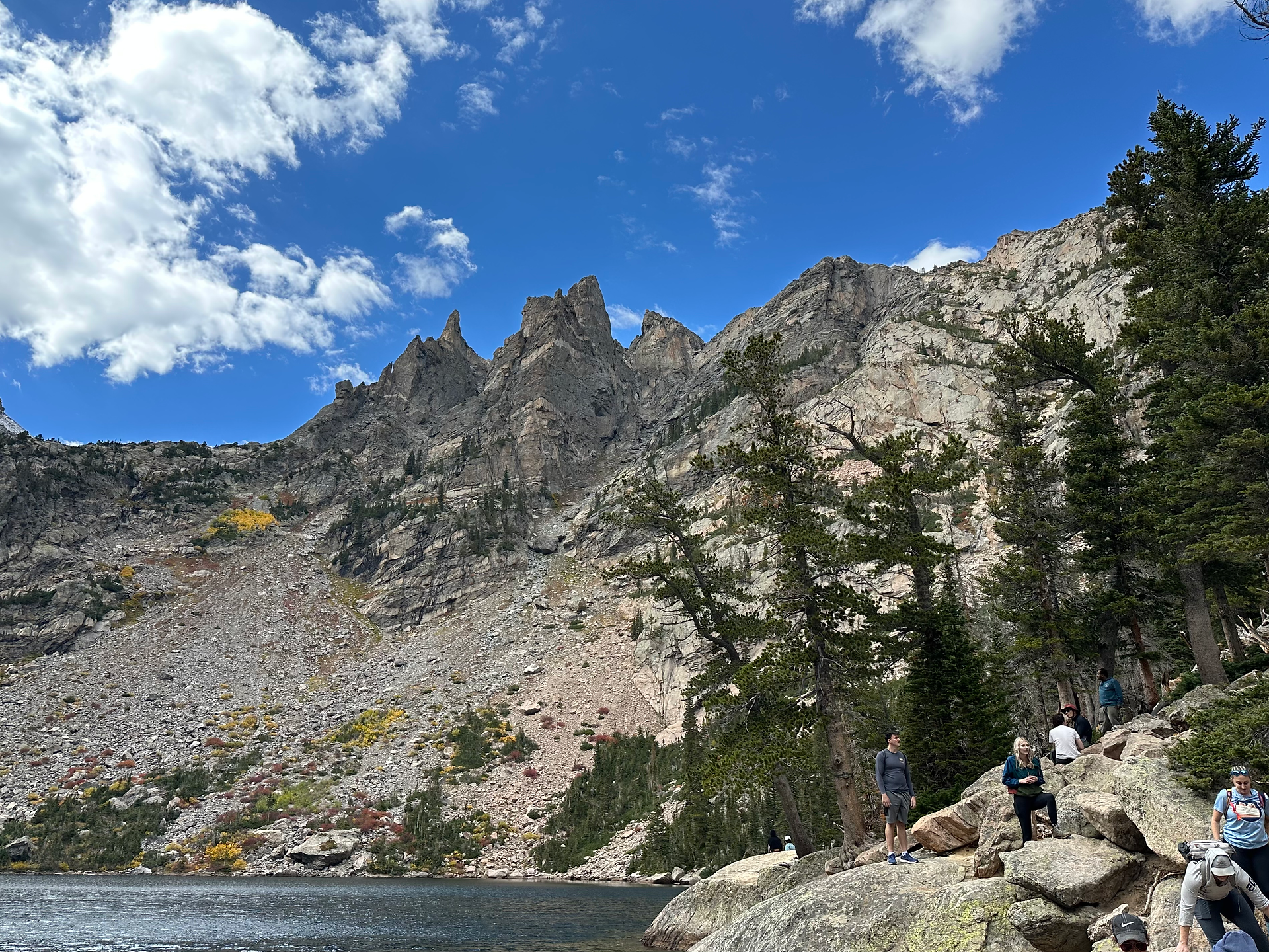 view of emerald lake with hallett and flattop peak and blue skies