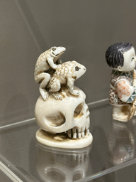 japanese netsuke of frogs on a skull