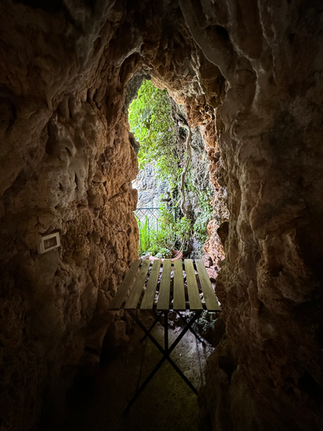 view of a table and trees outside il grotto inside il castello del capitano in the Parco di Villa Durazzo Pallavicini pegli italy