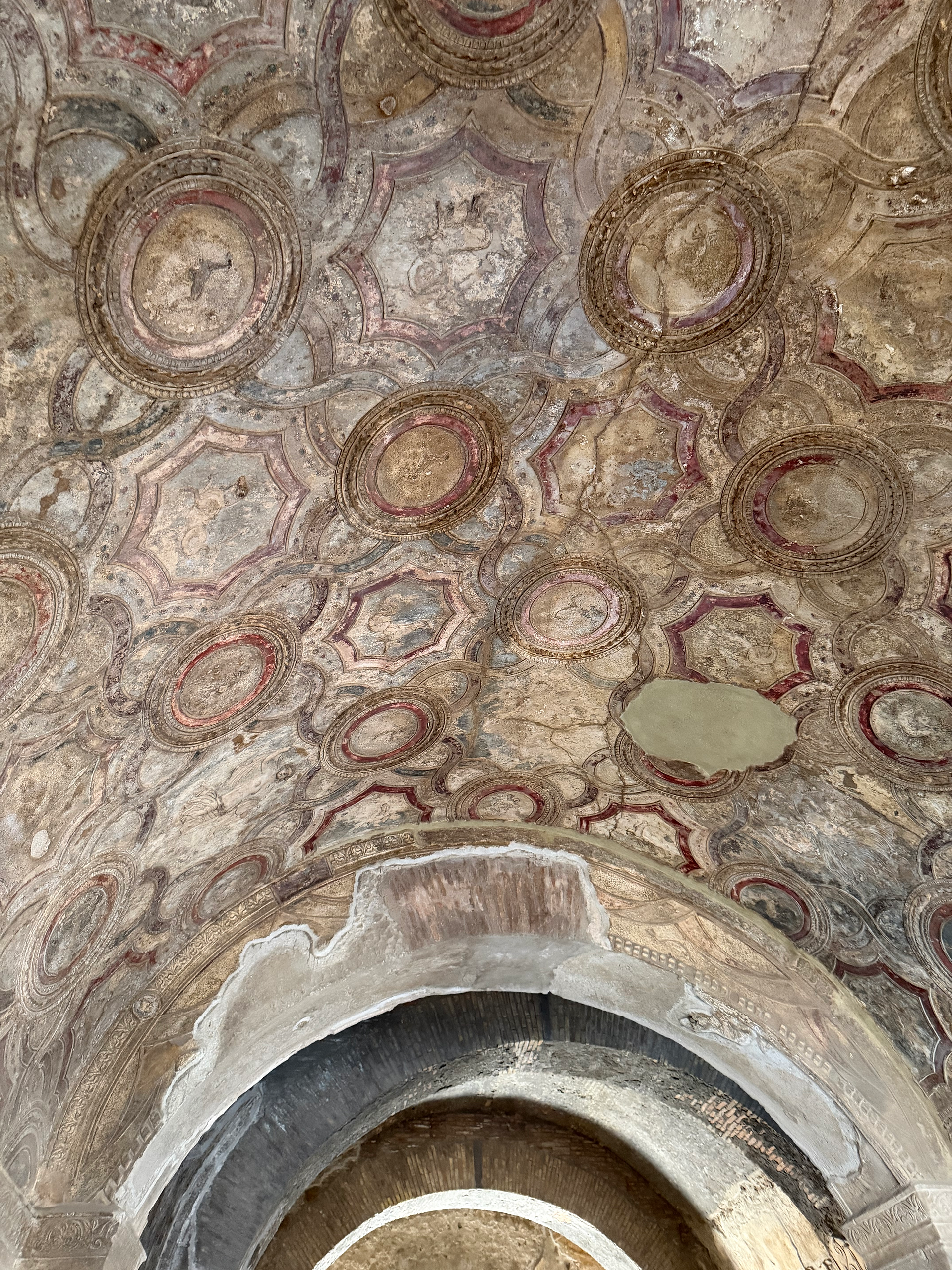 painted ceiling in the central bath in pompeii italy