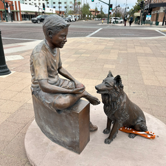 metal sculpture of a boy and dog in mesa arizona