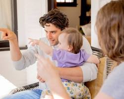 Toddler pointing at an object to demonstrate joint attention, a key social-emotional milestone in early childhood development.