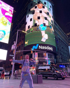 Person celebrating near large Nando's Times Square billboard
