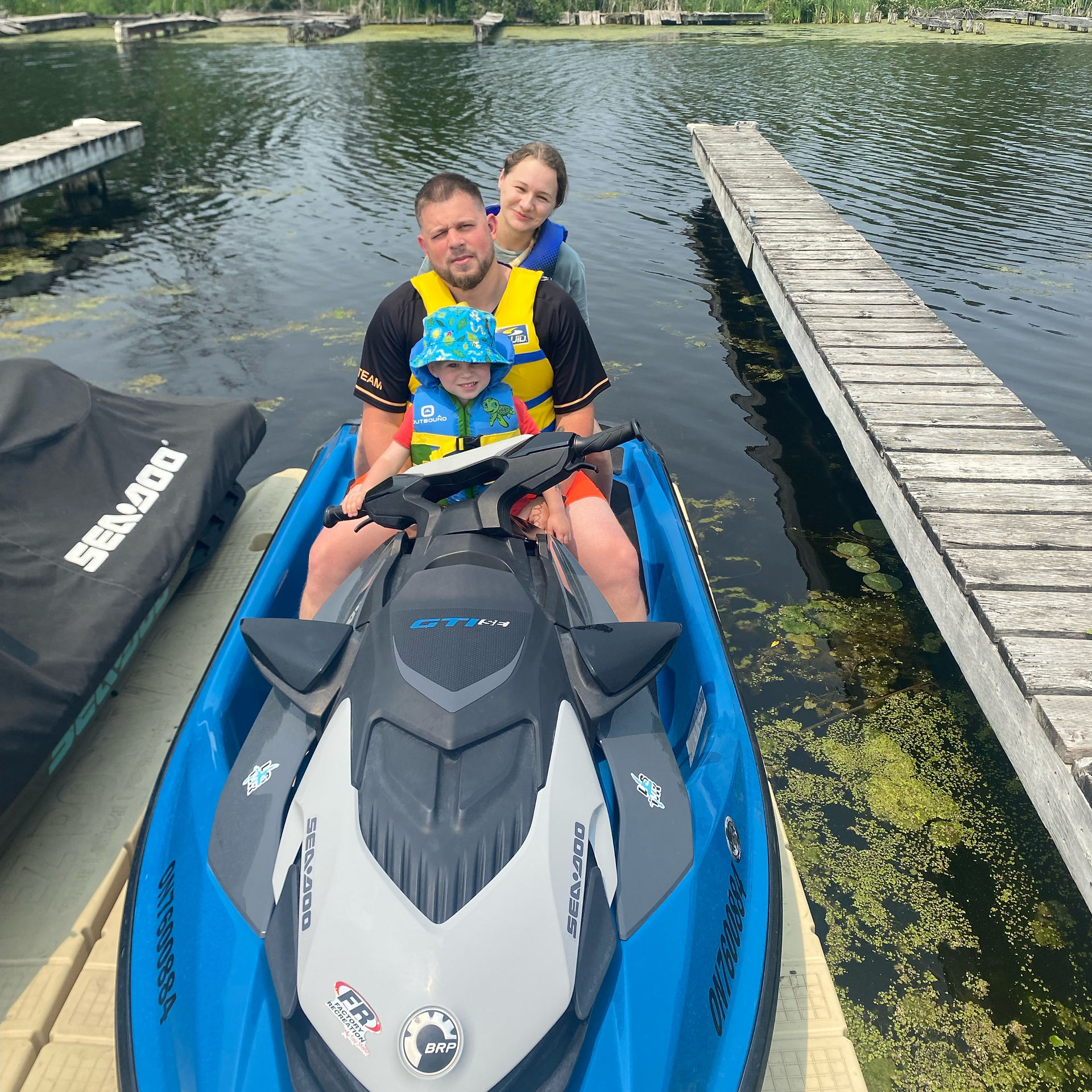 Man, woman and child on jetski