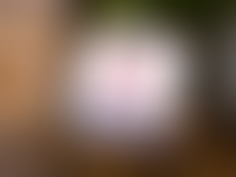 a laptop on a table showing a screen that says "authentic, not artificial" with the Ambition logo