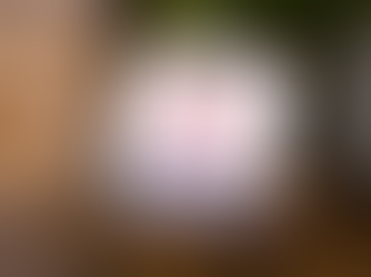 a laptop on a table showing a screen that says "authentic, not artificial" with the Ambition logo