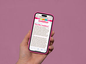 a person holding a phone against a pink background