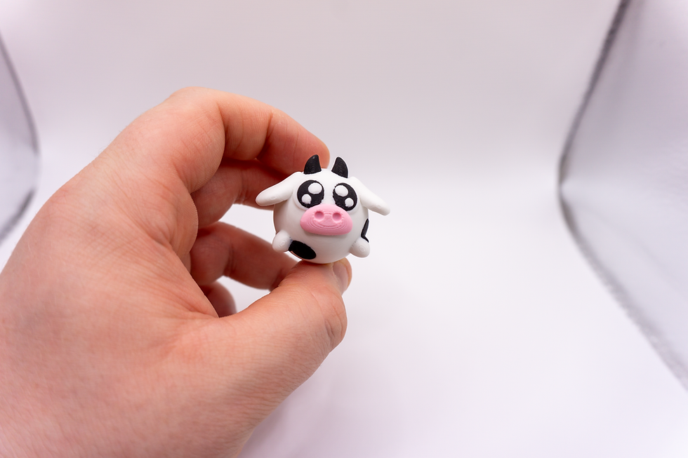 Thumbnail: Kawaii Cow Fidget Clicker - held in hand