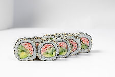 Sushi California roll in sesame with crab meat. Filled with crab meat, avocado and cucumbe
