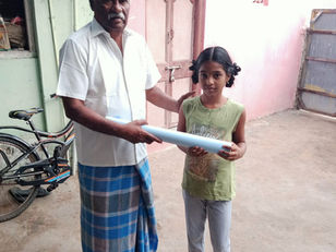 Giving stationery supplies to the kids from the Fishing community.