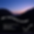 A picture of mountains at sunset, sky is blue and pink