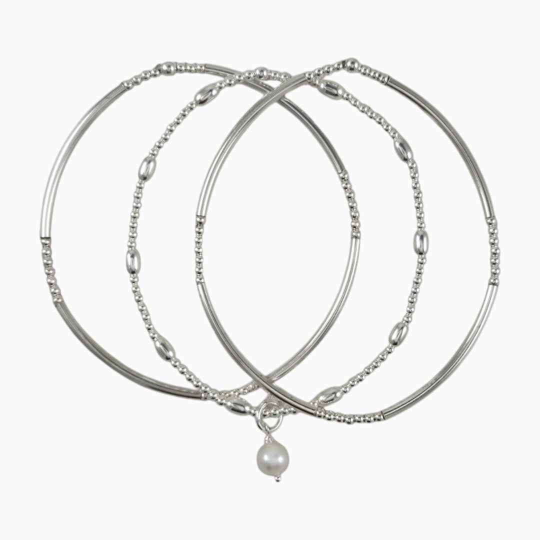 sterling silver trio of stretchy bracelets with a pearl dangle | www.elizaperry.com