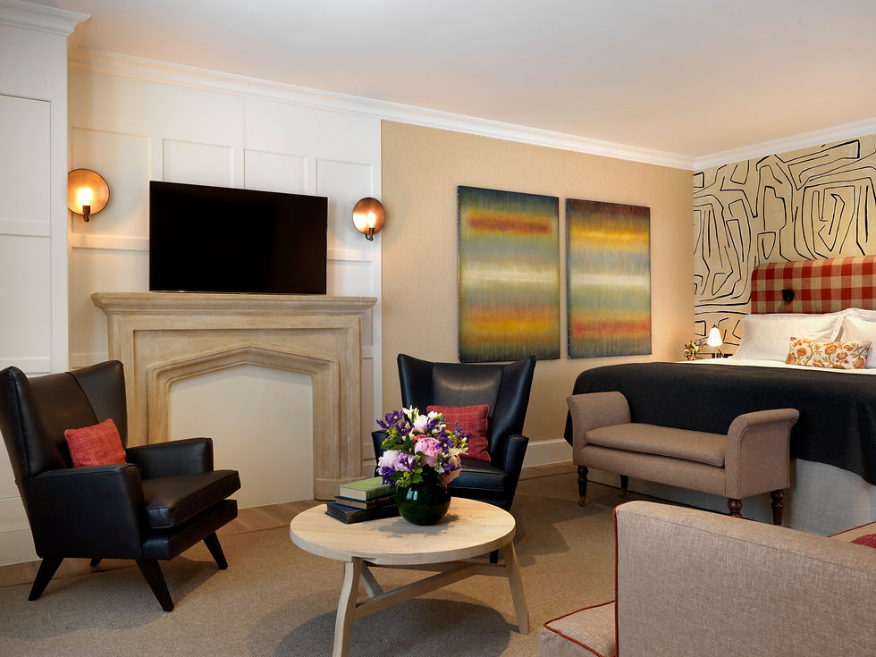 Spacious living room in the Gatehouse Two Bedroom Suite with contemporary artwork and elegant furnishings