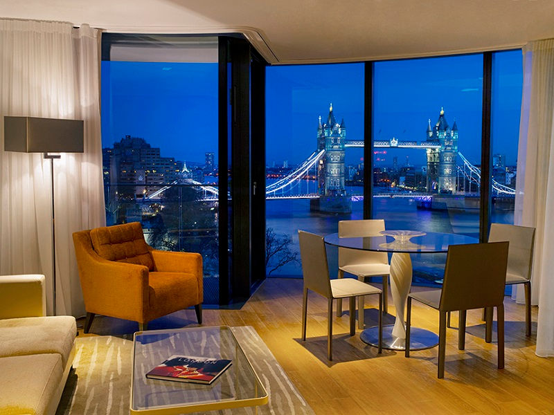 Living room with view of The Tower Bridge at Cheval Three Quays, London at Night