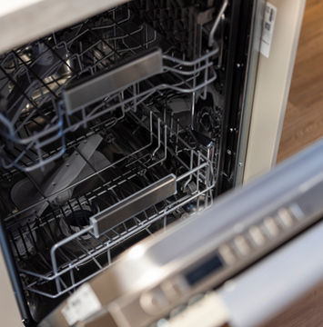Dishwasher drawer open in modern kitchen in Ariser - Zug Unique Apartment in Historic Building.
