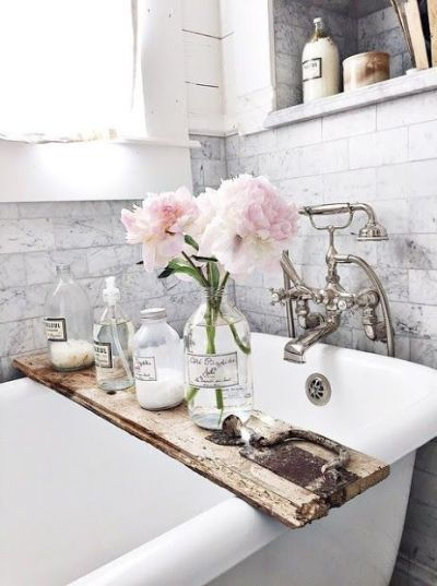 Marble subway tile with claw-footed tub in this beautiful bathroom.: