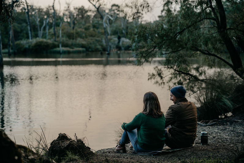 Mathew & Kim Kent of Beans+ sitting on bank of Margaret River