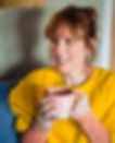 Fiona smiling with a cup of tea