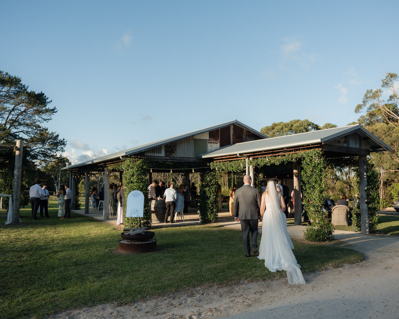 Couple walking hand in hand towards the Pavilion in the late afternoon