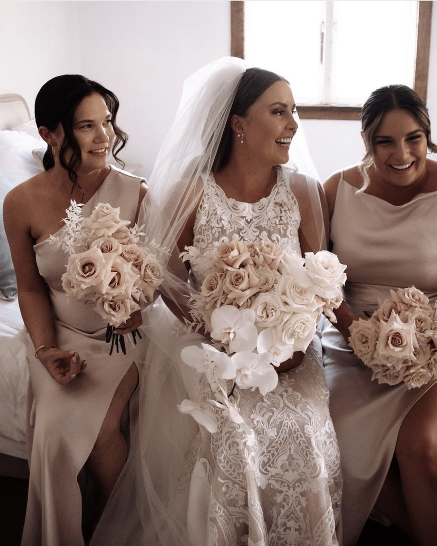 Bride laughing with her bridesmaids in the Loft