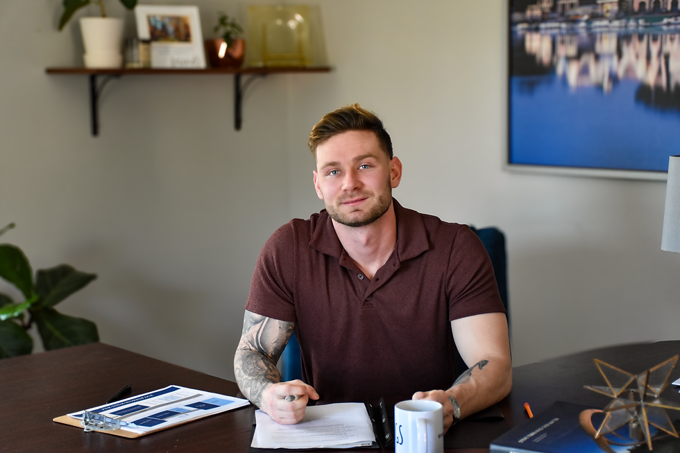 Mike Atchison of Pougs Insurance working at desk