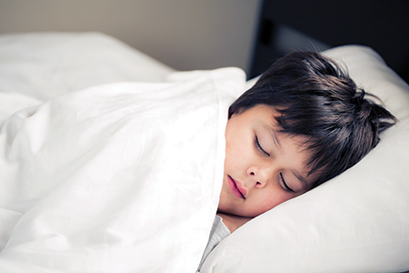 Child sleeping in bed.