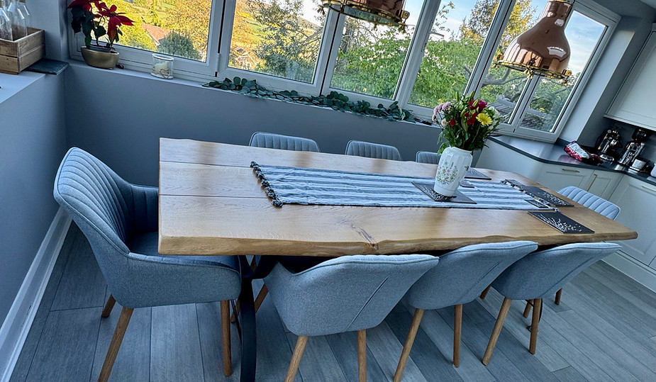 bespoke oak dinning table with handmade steel barreled legs.HEIC