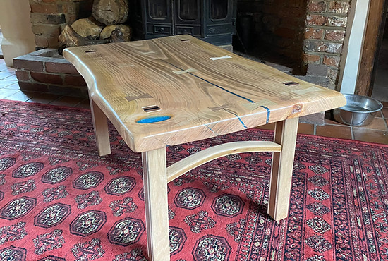 rustic coffee table made from a live edge cherry slab