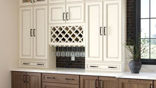 Wine bar in kitchen with vanilla-colored drawers and biscotti