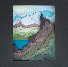 castle on peak overlooking lake and landscape beyond