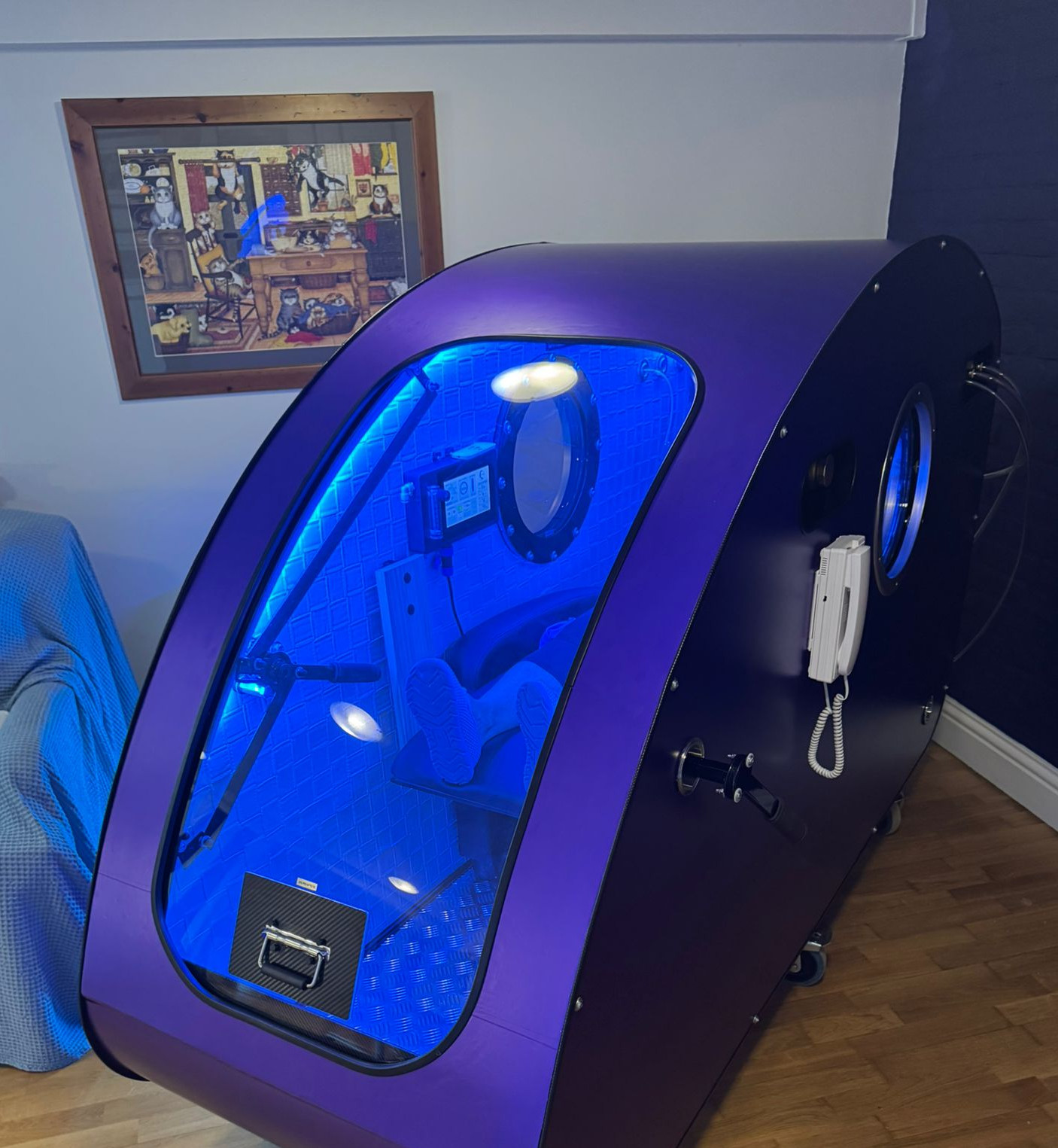 Innovative UK-manufactured steel hyperbaric chamber, featuring sleek design and advanced technology, shown in a comfortable indoor setting.