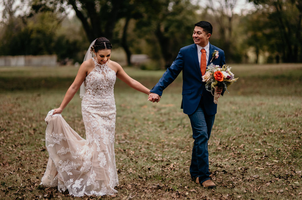 Photo of a bride and groom walking by a Nacogdoches wedding photographer