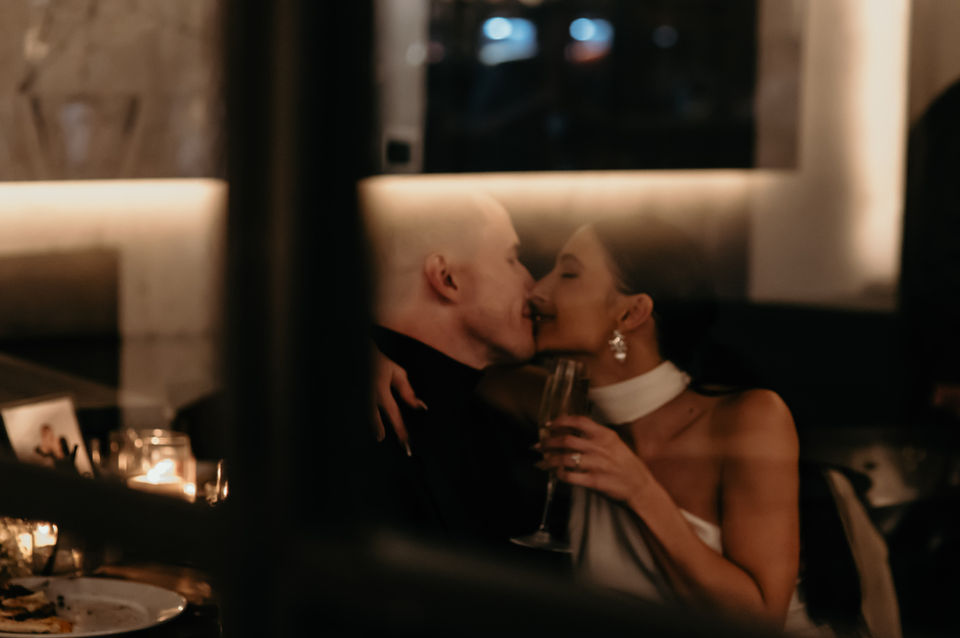 Photo of a couple kissing through a window taken by a Nacogdoches, Texas photographer