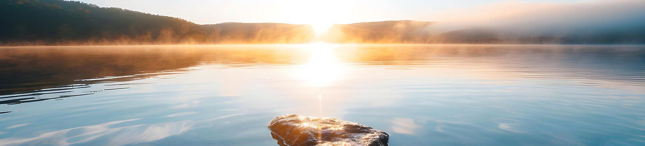 serene-lakeside-sunrise-with-mist-rising-gentle-light-casting-glow-landscape-concept-natur