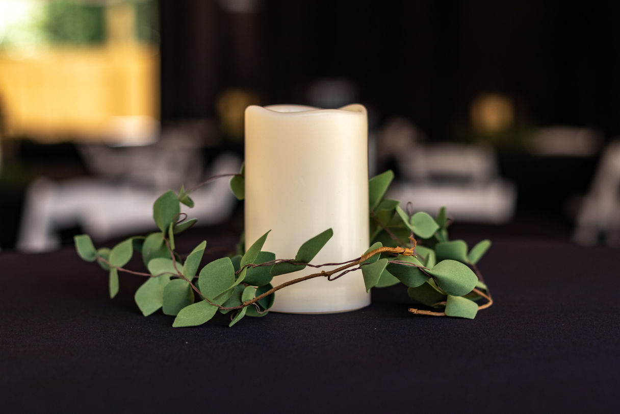 Candle and greenery centerpiece.